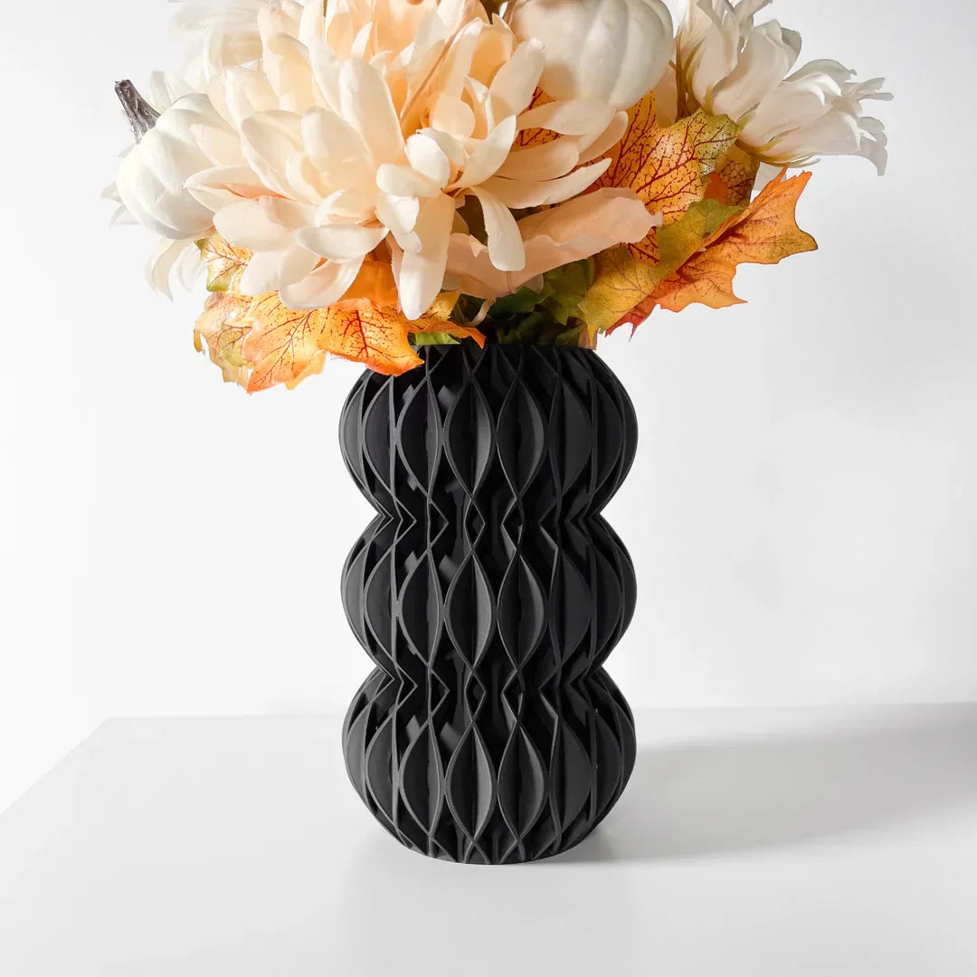 Modern 3D printed matte black geometric Revan vase with sculptural lattice design holding flowers