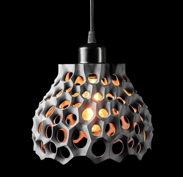Eco-friendly bioplastic pendant lamp with honeycomb design and warm LED light glow