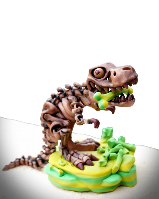 3D printed articulated T-Rex skeleton toy holding a green bone on a green and yellow base