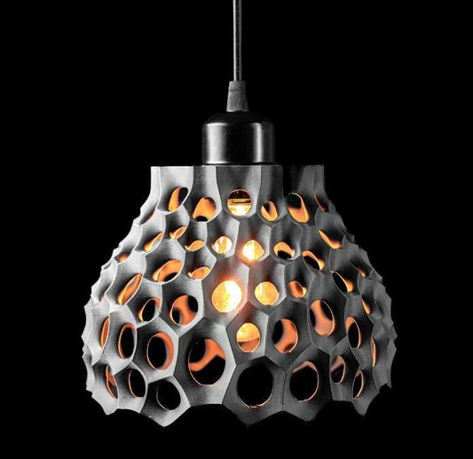 Eco-friendly bioplastic pendant lamp with honeycomb design and warm LED light glow